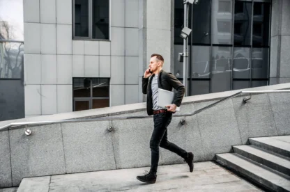 man with a laptop runs up the stairs to the office