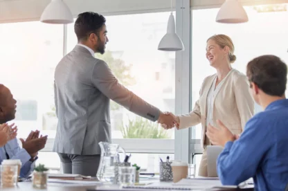 Handshake, applause and team of business people meeting for partnership, deal or agreement in office. Happy group clapping for collaboration, shaking hands and b2b integration, acquisition or success.