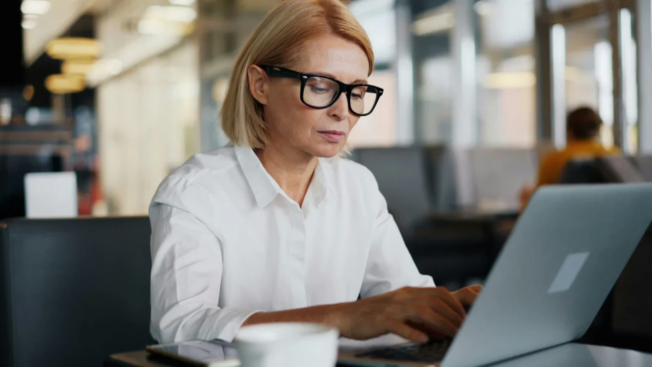 Female employee using laptop in office