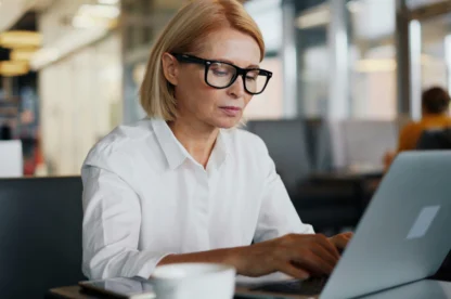 Female employee using laptop in office