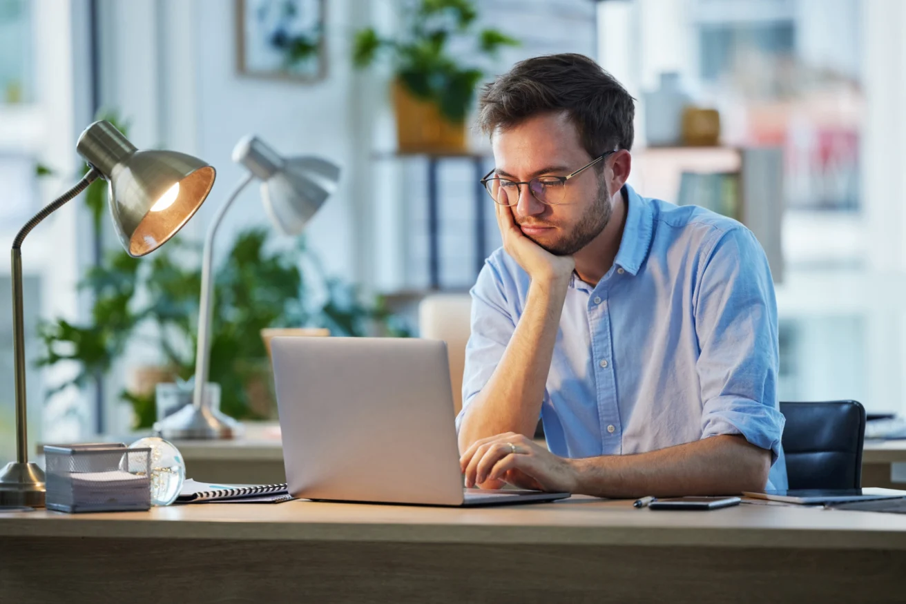 Fatigue, business and man with laptop, burnout and overworked with deadline, bored and sleepy. Person, consultant and employee with pc, exhausted and waiting for email notification and tired.